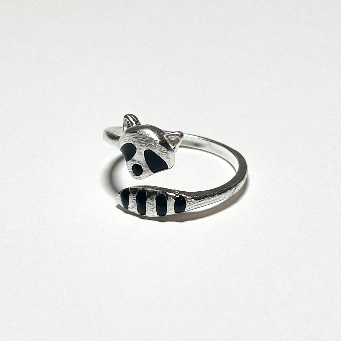An adjustable silver ring of a raccoon